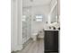 Modern bathroom featuring a glass shower, sleek vanity with a lighted mirror and a toilet at 7210 8Th N Ave, St Petersburg, FL 33710
