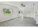 Bright bedroom featuring light gray floors, a ceiling fan, vaulted ceilings, two windows and louvered door closet at 7210 8Th N Ave, St Petersburg, FL 33710