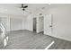 Spacious bedroom with ceiling fan, grey wood-look floors, with multiple closets at 7210 8Th N Ave, St Petersburg, FL 33710