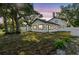 Beautiful renovated two-story home at dusk with modern exterior and a large yard at 7210 8Th N Ave, St Petersburg, FL 33710