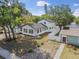 Aerial view of renovated home with black roof, white exterior paint, and fenced yard at 7210 8Th N Ave, St Petersburg, FL 33710