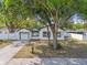 Charming renovated home with mature trees, a large yard, and black trim windows at 7210 8Th N Ave, St Petersburg, FL 33710