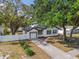 Lovely property featuring a well-maintained lawn and pristine white fencing that provides ample privacy at 7210 8Th N Ave, St Petersburg, FL 33710
