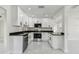 Modern kitchen with white cabinets, black hardware, stainless steel appliances and stone countertops at 7210 8Th N Ave, St Petersburg, FL 33710