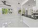 Open-concept living space with bright windows and granite kitchen bar at 7210 8Th N Ave, St Petersburg, FL 33710