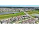 An aerial shot highlights a residential home, situated near a serene pond and in an established neighborhood at 7331 Canterbury Bells Ct, Tampa, FL 33619