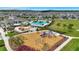 A stunning aerial perspective highlights the community's playground, pool, splash pad, and green spaces at 7331 Canterbury Bells Ct, Tampa, FL 33619