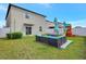 Backyard oasis with a patio set, green lawn, play area, and well-maintained fencing at 7331 Canterbury Bells Ct, Tampa, FL 33619