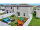 Well-maintained backyard featuring a patio set, playset, and lush green lawn at 7331 Canterbury Bells Ct, Tampa, FL 33619