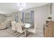 Dining area with stylish table and chairs, modern light fixture, and view of the living area at 7331 Canterbury Bells Ct, Tampa, FL 33619