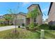 Two-story home featuring a neutral color palette, manicured lawn, and a two-car garage at 7331 Canterbury Bells Ct, Tampa, FL 33619