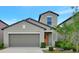 Charming two-story home with a well-manicured lawn, gray exterior, and attached two-car garage at 7331 Canterbury Bells Ct, Tampa, FL 33619