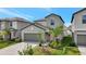 Charming two-story home with a well-manicured lawn, gray exterior, and attached two-car garage at 7331 Canterbury Bells Ct, Tampa, FL 33619