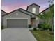 Charming home showcasing a well-maintained lawn and a two-car garage at 7331 Canterbury Bells Ct, Tampa, FL 33619