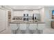 Modern kitchen featuring granite countertops, stainless steel appliances, and a stylish island with seating at 7331 Canterbury Bells Ct, Tampa, FL 33619