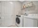 Bright laundry room equipped with modern washer and dryer units at 7331 Canterbury Bells Ct, Tampa, FL 33619