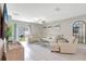 Bright living room with plush sectional sofa, modern decor, and view of the outdoor patio at 7331 Canterbury Bells Ct, Tampa, FL 33619