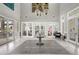 An elegant lobby boasts contemporary lighting, tile flooring, and glass door access to outdoor amenities at 7331 Canterbury Bells Ct, Tampa, FL 33619