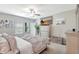 Bright main bedroom with ceiling fan, dresser and television for relaxing and unwinding at 7331 Canterbury Bells Ct, Tampa, FL 33619