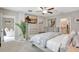 Serene main bedroom featuring a ceiling fan, large TV, and access to an en-suite bathroom at 7331 Canterbury Bells Ct, Tampa, FL 33619