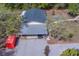 Single-story home with a covered parking area and mature trees at 9802 Eden Ave, Hudson, FL 34667