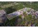 Aerial view of a property with an outlined property line and a mix of wooded areas and open spaces at 9802 Eden Ave, Hudson, FL 34667