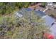 Single-story home partially hidden by trees and surrounded by lush greenery at 9802 Eden Ave, Hudson, FL 34667