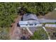 View of a small home with an aging roof and a fenced yard at 9802 Eden Ave, Hudson, FL 34667