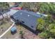 Spacious single-story home featuring a well-kept roof and mature trees at 9802 Eden Ave, Hudson, FL 34667