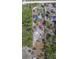 High angle showing property layout, outlining boundaries, buildings, and surrounding trees at 9802 Eden Ave, Hudson, FL 34667