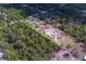Expansive aerial view of a large property with mature trees and a house nestled among them at 9802 Eden Ave, Hudson, FL 34667