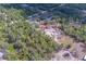 Expansive aerial view of a large property with mature trees and a house nestled among them at 9802 Eden Ave, Hudson, FL 34667