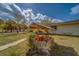 The backyard view shows the home's exterior and the well with a stone surround at 9802 Eden Ave, Hudson, FL 34667