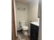 Bathroom with black vanity and modern fixtures at 9802 Eden Ave, Hudson, FL 34667