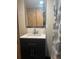 Bathroom vanity with modern fixtures and shower curtain at 9802 Eden Ave, Hudson, FL 34667