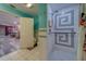 A view into the shower from a bathroom with a Mickey Mouse shower curtain and bright blue walls at 9802 Eden Ave, Hudson, FL 34667