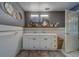 Dual sink vanity with decorative mirrors, tiled backsplash, and ample storage in this bathroom at 9802 Eden Ave, Hudson, FL 34667