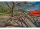 Exterior features a lush yard, mature trees and storage shed in the foreground at 9802 Eden Ave, Hudson, FL 34667