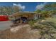 Exterior showing car, carport, and items stored nearby at 9802 Eden Ave, Hudson, FL 34667