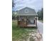 Quaint exterior with covered porch and outdoor seating area at 9802 Eden Ave, Hudson, FL 34667