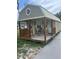 A cute cottage with a porch features outdoor seating and a covered entry at 9802 Eden Ave, Hudson, FL 34667