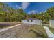 View of the home's exterior with a visible fence and greenery at 9802 Eden Ave, Hudson, FL 34667