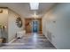 Inviting foyer with wood-look flooring, a skylight, bench seating, and a decorative wall mirror at 9802 Eden Ave, Hudson, FL 34667