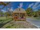 Charming tiny home with a cozy wooden front porch and a welcoming entryway at 9802 Eden Ave, Hudson, FL 34667