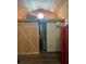 Interior view with wood flooring, barn door, and view into the bathroom at 9802 Eden Ave, Hudson, FL 34667