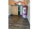 Interior view with wood flooring and a modern sliding barn door leading to the bathroom at 9802 Eden Ave, Hudson, FL 34667