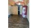 Interior view with wood flooring and a modern sliding barn door leading to the bathroom at 9802 Eden Ave, Hudson, FL 34667