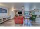 Spacious living room featuring wood-look floors, modern furniture, ceiling fans, and natural light at 9802 Eden Ave, Hudson, FL 34667