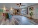 Bright living room featuring wood-look floors, ceiling fans, and view of the spacious backyard at 9802 Eden Ave, Hudson, FL 34667