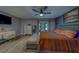 Spacious primary bedroom with a comfortable bed, desk area, and access to an outdoor balcony, offers relaxation at 9802 Eden Ave, Hudson, FL 34667